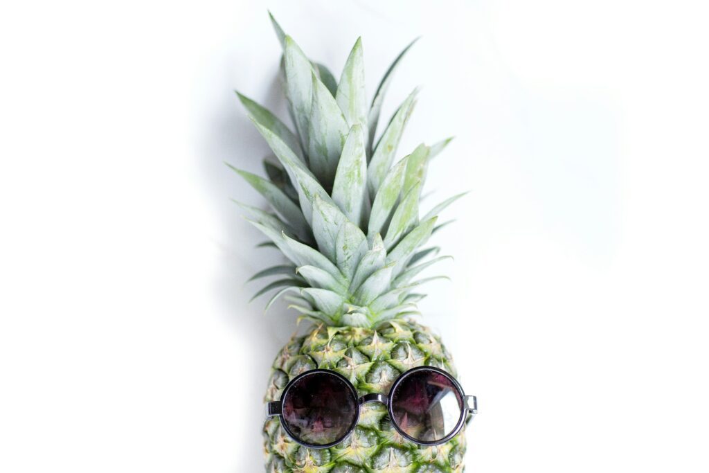 pineapple wearing sunglasses on white background to represent looking after your brand reputation